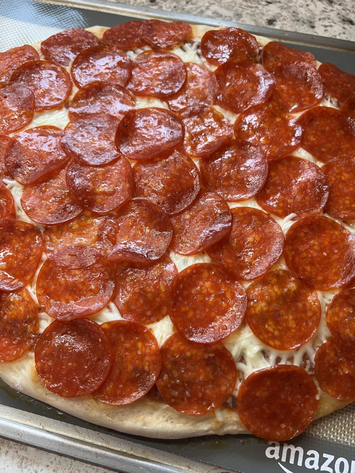 homemade pizza covered in pepperoni