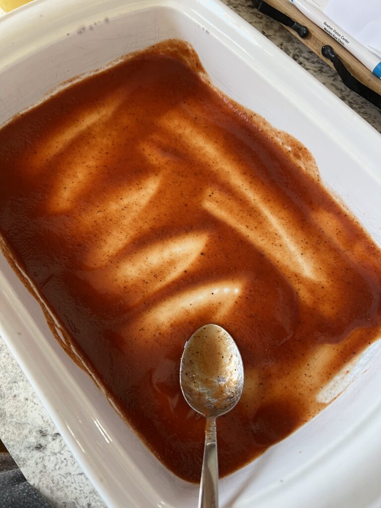 chili tomato sauce in the bottom of baking dish