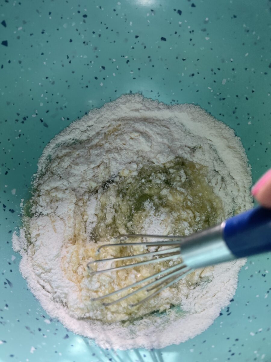 pudding being whisked into peach syrup for fruit salad base