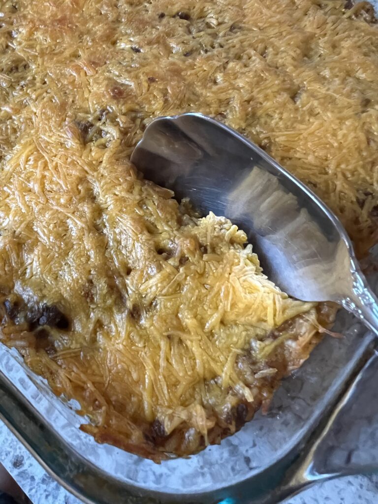 easy cheesy hamburger rice bake with serving spoon